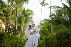 Couple kissing surrounded by tropical palm trees
