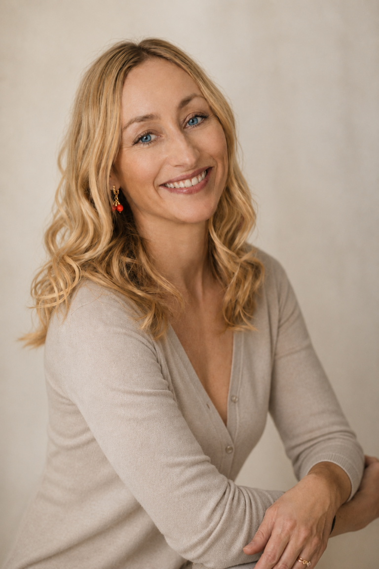 Anna Belichenko, Founder & Lead Planner at Belka Destination Weddings, portrait against a dark background